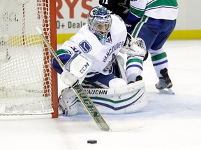 SAN JOSE, CA - NOVEMBER 06:  Ryan Miller #30 of the Vancouver Canucks makes a save during their game against the San Jose Sharks at SAP Center on November 6, 2014 in San Jose, California.  (Photo by Ezra Shaw/Getty Images)