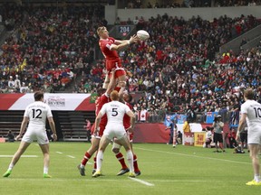 VANCOUVER , BC - MARCH 13:  John Moonlight of Canada receives a pass during their match against England at the Canada Sevens, the sixth round of the HSBC Sevens World Series at  BC Place stadium on March 13 in Vancouver, British Columbia   (Photo by  Jeff Vinnick / Getty Images for HSBC)