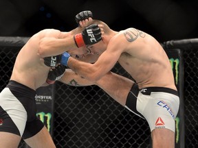 BRISBANE, AUSTRALIA - MARCH 20:  Johnny Case and Jake Matthews trade blows during their UFC Lightweight Bout at UFC Brisbane on March 20, 2016 in Brisbane, Australia. (Photo by Bradley Kanaris/Getty Images)