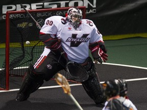 Buffalo Bandit Dhane Smith scores on Vancouver Stealth goalie Tyler Richards in a NLL lacrosse game at the LEC on Saturday night. (Gerry Kahrmann/PNG)
