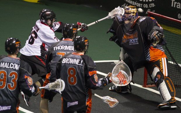 Vancouver Stealth rookie Jordan Durston makes it through a trio of Buffalo Bandits to score on Bandits goalie Anthony Cosmo (Gerry Kahrmann/PNG)
