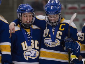 UBC Thunderbirds Stephanie Schaupmeyer (right) and Shiayli Toni with their silver medals after losing to the University of Montreal during in the 2016 CIS women's hockey championship in Calgary.
(Rich Lam/UBC Athletics)