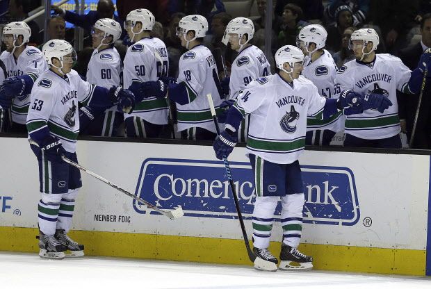 Vancouver Canucks' Alex Burrows (14) is congratulated after scoring against the San Jose Sharks during the third period of an NHL hockey game Saturday, March 5, 2016, in San Jose, Calif. Vancouver won 4-2. (AP Photo/Ben Margot)