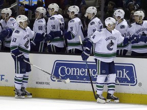 Vancouver Canucks' Alex Burrows (14) is congratulated after scoring against the San Jose Sharks during the third period of an NHL hockey game Saturday, March 5, 2016, in San Jose, Calif. Vancouver won 4-2. (AP Photo/Ben Margot)