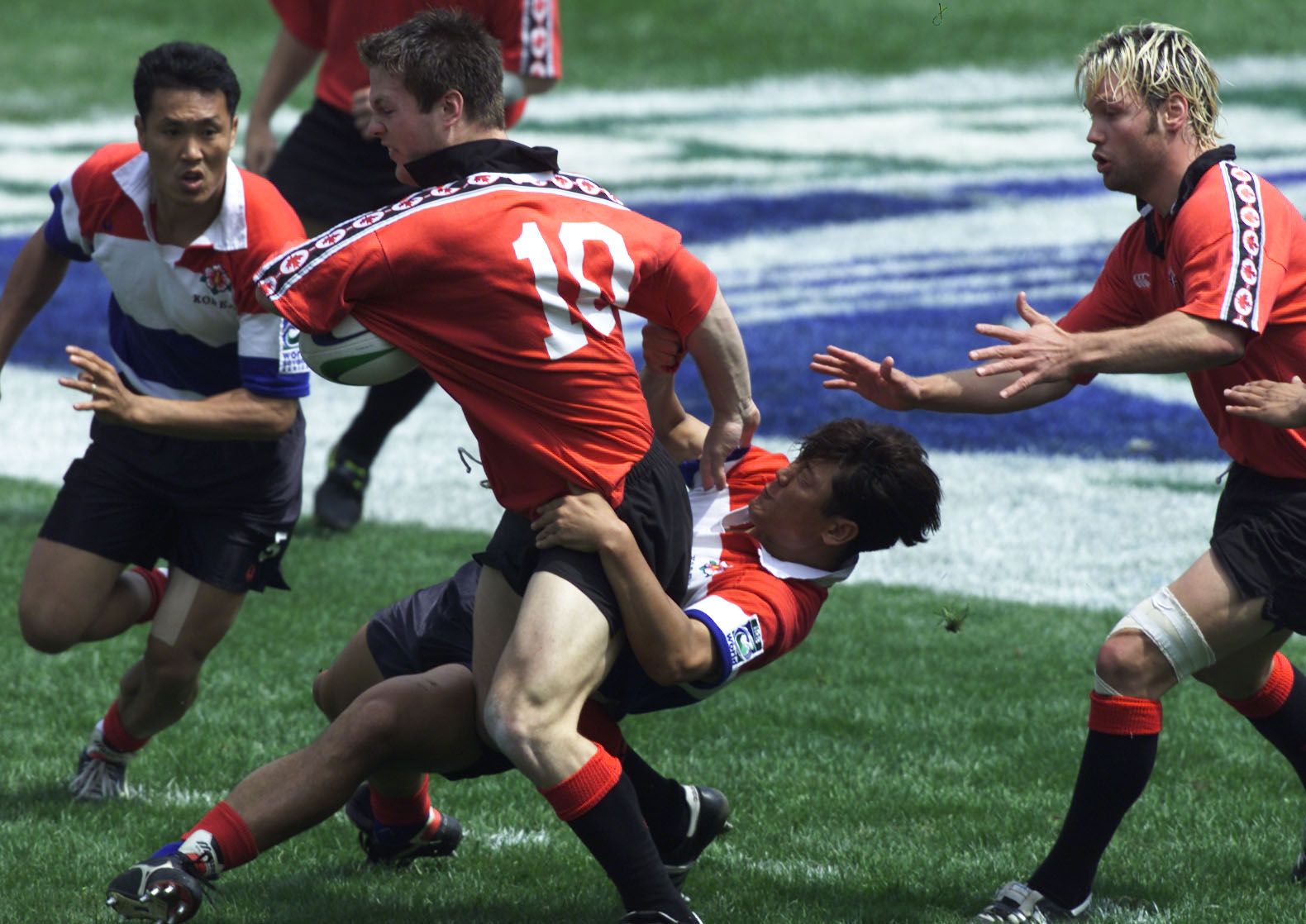 07 April 2001: John Cannon of Canada is tackled by the South Korean defence during the IRB World Sevens Series, Shanghai 7's at the Pudong Yuan Shen Stadium, Shanghai, China.   Mandatory Credit: Stanley Chou/ALLSPORT