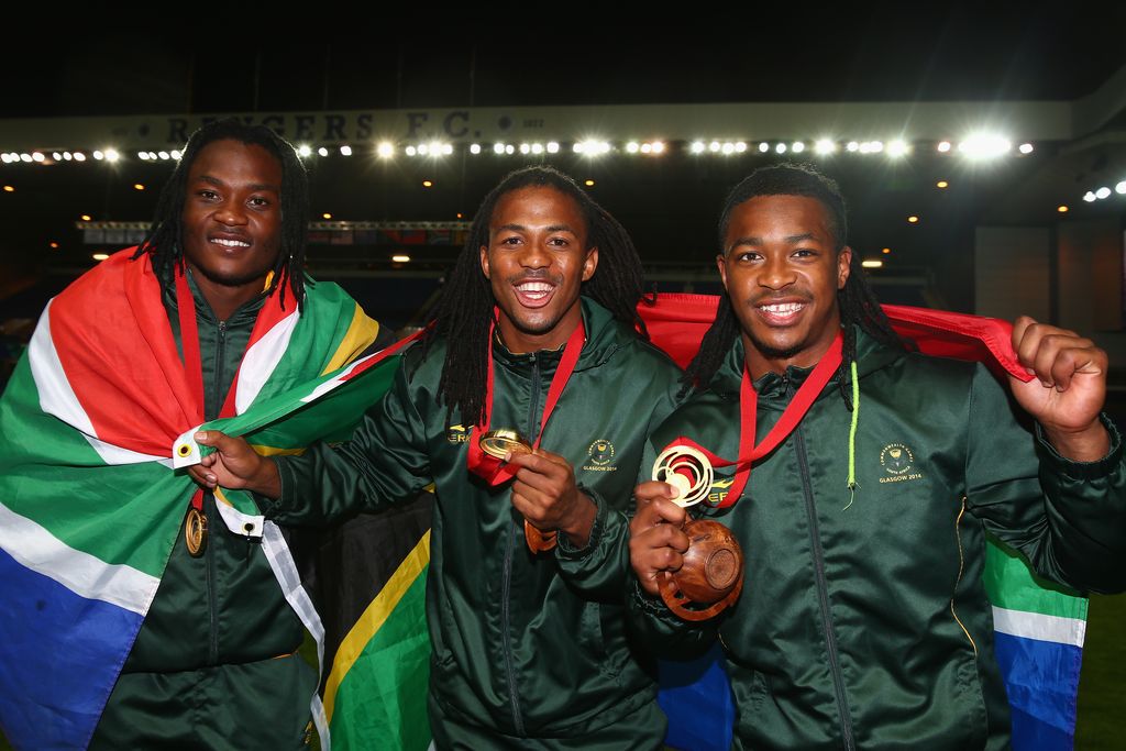 GLASGOW, SCOTLAND - JULY 27:  South African players (L-R) Seabelo Senatla, Cecil Africa and Branco du Preez celebrate after win after the final match between South Africa and New Zealand at Ibrox Stadium during day four of the Glasgow 2014 Commonwealth Games on July 27, 2014 in Glasgow, United Kingdom.  (Photo by Julian Finney/Getty Images)