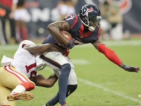 Uzoma Nwachukwu of the Houston Texans is tackled by Kassim Osgood of the San Francisco 49ers in the second half in a pre-season NFL game on August 28, 2014 at NRG Stadium in Houston, Texas. Nwachukwu signed with the B.C. Lions on Thursday. (Photo by Thomas B. Shea/Getty Images)