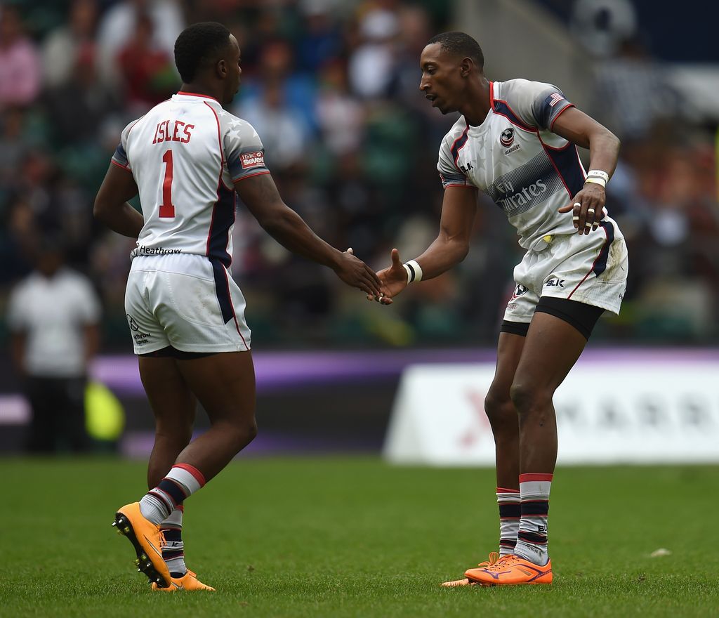 LONDON, ENGLAND - MAY 17:  Perry Baker of USA shakes hands with Carlin Isles as they substitute each other during the Cup Final match between Australia and USA in the Marriott London Sevens at Twickenham Stadium on May 17, 2015 in London, England.  (Photo by Christopher Lee/Getty Images)