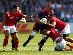 Georgia captain Mamuka Gorgodze is tackled by the Tonga defence during the 2015 Rugby World Cup.