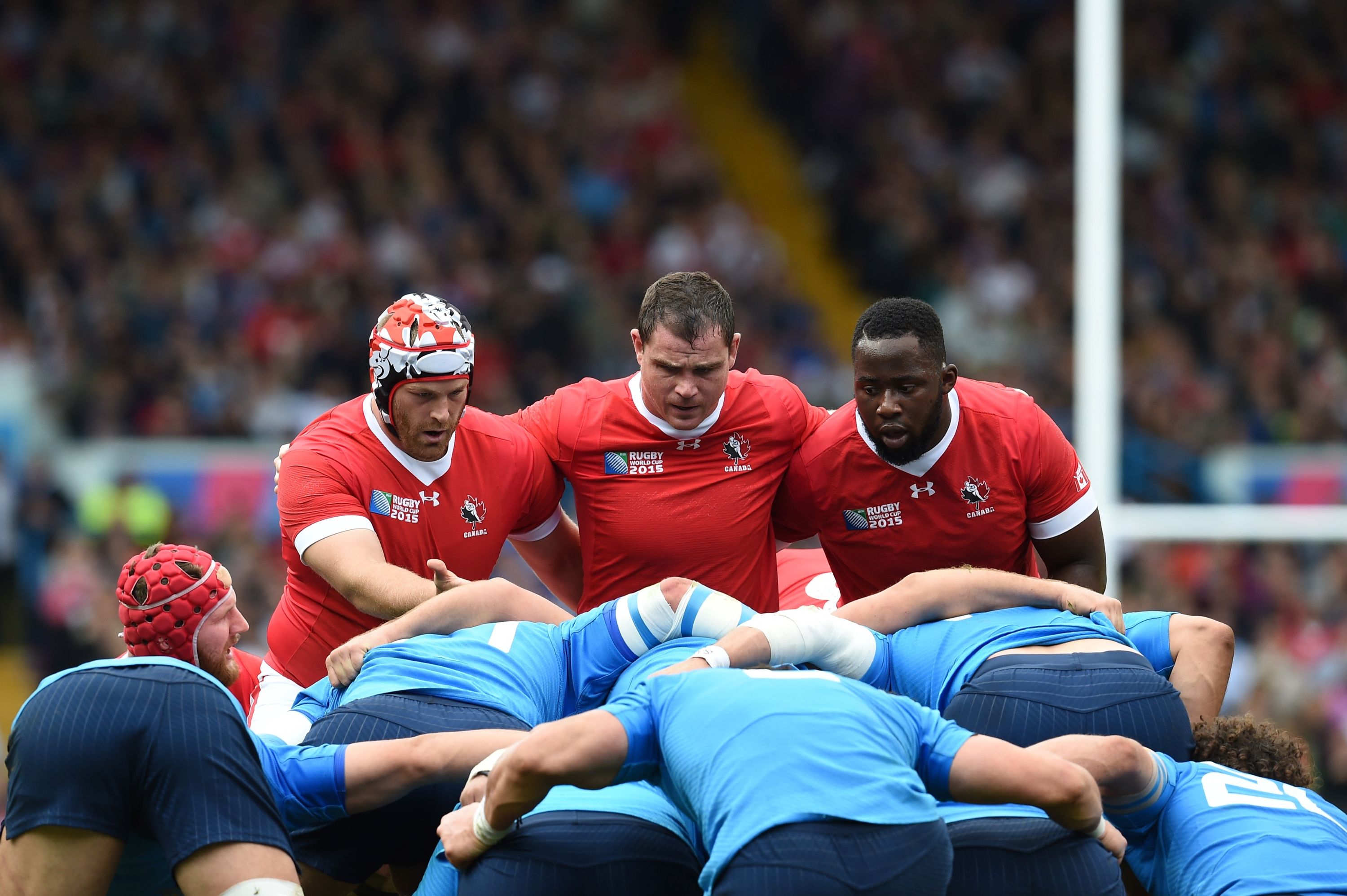 Canada's lock Jebb Sinclair (L), Canada's hooker Aaron Carpenter (C) and Canada's prop Djustice Sears-Duru (R) prepare for a scrum  during a Pool D match of the 2015 Rugby World Cup between Italy and Canada at Elland Road in Leeds, north England, on September 26, 2015.  AFP PHOTO / PAUL ELLIS RESTRICTED TO EDITORIAL USE, NO USE IN LIVE MATCH TRACKING SERVICES, TO BE USED AS NON-SEQUENTIAL STILLS        (Photo credit should read PAUL ELLIS/AFP/Getty Images)