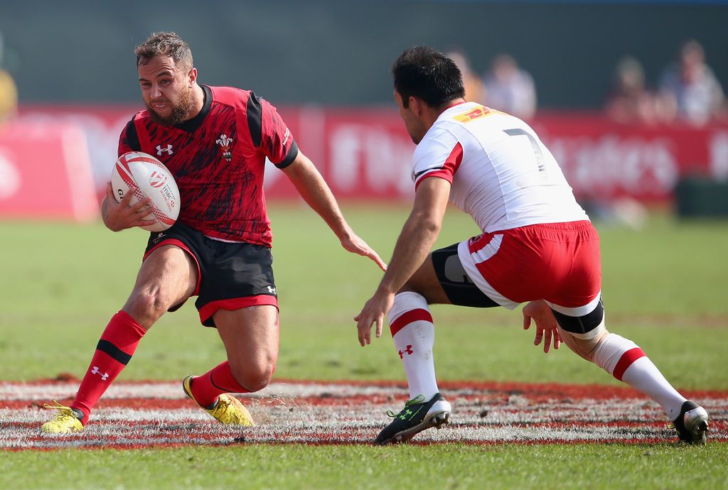 DUBAI, UNITED ARAB EMIRATES - DECEMBER 05:  Luke Treharne of Wales evades a tackle by Phillip Mack of Canada during the Emirates Dubai Rugby Sevens - HSBC World Rugby Sevens Series at The Sevens Stadium  on December 5, 2015 in Dubai, United Arab Emirates.  (Photo by Francois Nel/Getty Images)