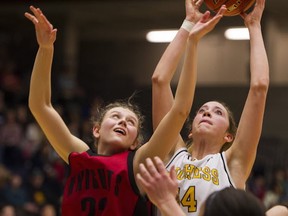 Duchess Park's Marcie Schlick (right) outreaches STM's Maya Iwan for a rebound Friday at the Langley Events Centre. (Gerry Kahrmann, PNG)