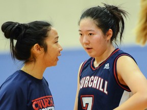 Churchill coach Jennifer Eng offers words of encouragement to guard Cecilia Bao during the 'Dawgs Top 10 Shoot-Out finale against the Handsworth Royals. (Howard Tsumura, PNG photo)