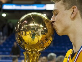 Grant Shephard, Kelowna's tournament MVP, went from kissing them off to glass to kissing the golden bauble! (Richard Lam, PNG)