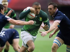 South Africa's Bryan Habana, centre, carries the ball past Scotland's Nick McLennan, left, and Scott Riddell during World Rugby Sevens Series' Canada Sevens tournament action, in Vancouver, B.C., on Saturday March 12, 2016. THE CANADIAN PRESS/Darryl Dyck