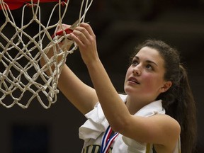 Argyle Pipers' Georgia Swant cuts down the victorious net after the North Vancouver school won the Telus BC junior girls basketball championship Saturday at the Langley Events Centre. (PNG photo)