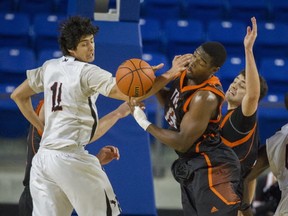 Thompson River's Gerard Gore (right) battles Carleton's TJ Lall during CIS Final 8 quarterfinal at UBC (Arlen Redekop, PNG)