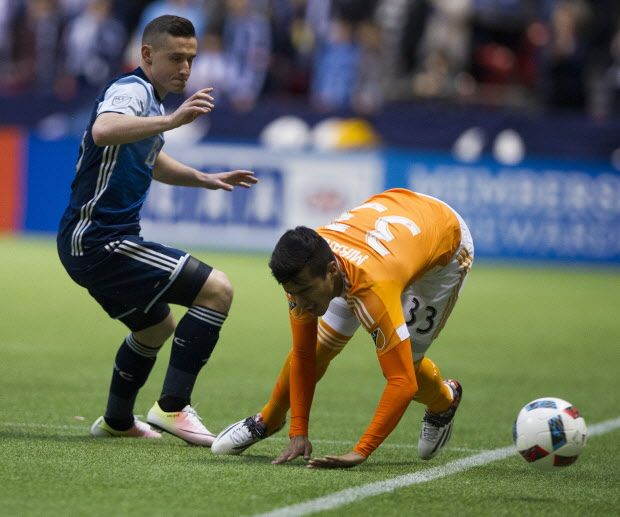 VANCOUVER March 26 2016. Vancouver Whitecaps FC #8 Fraser Aird forces Houston Dynamo #33 Leonel Miranda to loose the ball in a regular season MLS soccer game at BC Place, Vancouver March 26 2016. Gerry Kahrmann / PNG staff photo) / PNG staff photo) ( For Prov /Sun Sports ) 00042411A [PNG Merlin Archive]