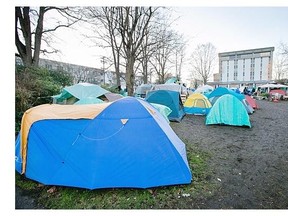 Homeless people fill a tent city on provincially owned property next to the Victoria courthouse on Burdett Avenue.