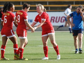 Charity Williams, Ghislaine Landry and Kayla Moleschi celebrate their win over France on day one of the Atlanta 7s. TAMI CHAPPELL/AFP/Getty Images