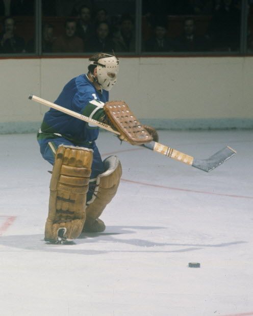 MONTREAL, CANADA- CIRCA 1970: Charlie Hodge #1 of the Vancouver Canucks saves a shot during a game against the Montreal Canadiens Circa 1970 at the Montreal Forum in Montreal, Quebec, Canada. (Photo by Denis Brodeur/NHLI via Getty Images) [PNG Merlin Archive]