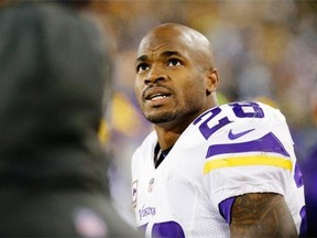 Adrian Peterson rests during the second half against the Green Bay Packers at Lambeau Field on Sunday.
