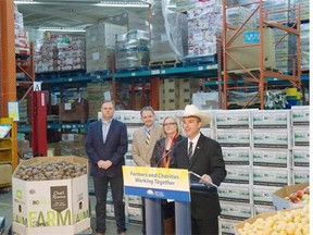 Agriculture Minister Norm Letnick, in white hat, announces the Farmers’ Food Donation Tax Credit program Thursday in Vancouver.    Jason Payne/PNG