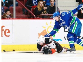 Alex Burrows checks Ryan Kesler of the Anaheim Ducks during Friday’s game at Rogers Arena. Both players represent the past, in a sense. Kesler, the former Duck who was booed lustily all night, and Burrows, who could be traded for a player to help the Canucks in the future. — Getty Images