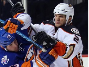 Anaheim Ducks defenceman Kevin Bieksa gets his stick up on Casey Cizikas of the New York Islanders last week. Bieksa, whether with the Canucks or Ducks, plays with heart and an edge.