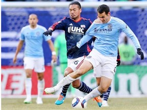 Andrew Jacobson, right, of New York City FC gets a tug from former Whitecap Daigo Kobayashi of the New England Revolution last season. Jacobson, obtained by the Caps for targeted allocation money, should be ready to play for Vancouver Saturday in Seattle.