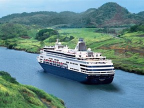 A bird’s-eye view shows the Holland America’s cruise ship Oosterdam sailing along a channel of the Panama Canal with verdant hills on each side.