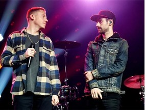 Recording artists Macklemore, left, and Ryan Lewis speak at the iHeartRadio Theater on February 24, 2016, in Burbank, California.