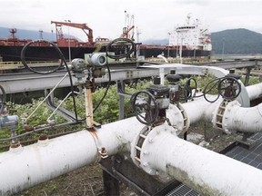 A ship receives its load of oil from the Kinder Morgan Trans Mountain Expansion Project's Westeridge loading dock in Burnaby, British Columbia, on June 4, 2015.