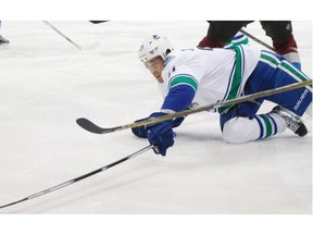 Canucks centre Brandon Sutter reaches out to control a loose puck during Tuesday’s 3-1 win over the Colorado Avalanche. He had just returned after missing 2 1/2 months with a sports hernia, but suffered a broken jaw in the second period.  — AP