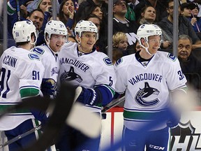 From left: Jared McCann, Ben Hutton, Luca Sbisa and Jannik Hansen -- all of whom figure prominently in our end-of-season Canucks survey -- celebrate a goal in Brooklyn before presumably heading out to some hipster eatery.