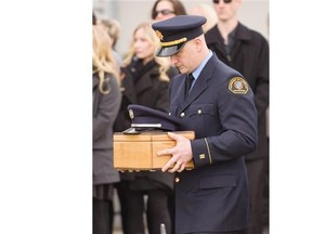 Captain Piticco, a retired member worked for the Surrey Fire Service for 32 years, is brought in by his fellow firefighters for his funeral in Surrey, BC, January, 24, 2016.