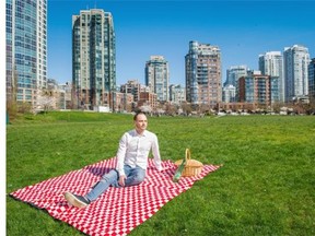 Catering company owner Simon Pearson-Roach relaxes in Thursday’s sunshine at David Lam Park in Vancouver with a picnic lunch and bottled water. He says allowing consumption of alcohol in parks and on beaches could boost tourism and ‘would be great for my business.’    Ric Ernst/PNG