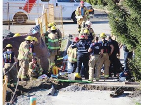 Coquitlam fire crews at the scene of a trench collapse at a construction site in the 200-block of Hart Street in Coquitlam at 10:50 a.m., Tuesday, Feb. 23, 2016. A man trapped in the trench was eventually freed, but in cardiac arrest. He was pronounced dead soon after.
