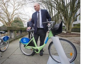 CycleHop founder and CEO Josh Squire displays a demonstration model of the bicycles to be used in Vancouver’s bike-share program.    Jason Payne/PNG