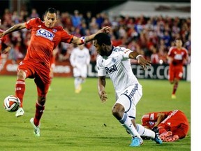 FC Dallas’s Blas Perez, left, controls the ball in front of Vancouver’s Kendall Waston in a 2014 game at Frisco, Texas.    — The Associated Press files