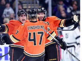 David Perron, left, Ryan Kesler congratulate teammate Hampus Lindholm after he scored in a 4-2 victory over the Los Angeles Kings on Feb. 4 in Los Angeles.