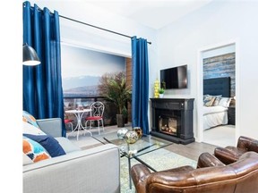 The display suite living area is fitted with bold, blue drapery and vintage-looking leather chairs.