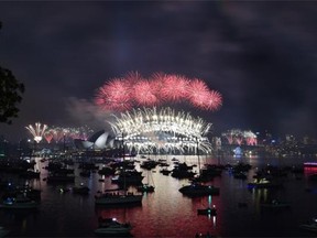 Fireworks light up the sky over Sydney’s Opera House, left, and Harbour Bridge during Australian new year celebrations Jan. 1. Many folks have difficulty keeping new-year resolutions, experts say, because they make their resolutions too big.