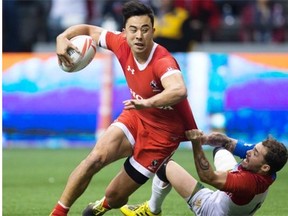 France’s Terry Bouhraoua, right, tries to bring down Canadian hero Nathan Hirayama of Richmond during the Canada Sevens Bowl final on Sunday at B.C. Place Stadium.