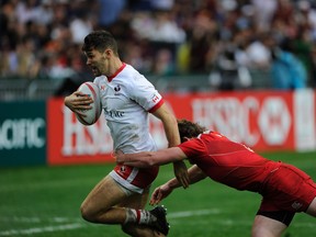 Justine Douglas of Canada tries to break the tackle of Vladislav Sozonov of Russia during the Shield Final at the Hong Kong Sevens. (ISAAC LAWRENCE/AFP/Getty Images)