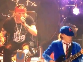 Axl Rose appears on stage with Angus Young from AC/DC.