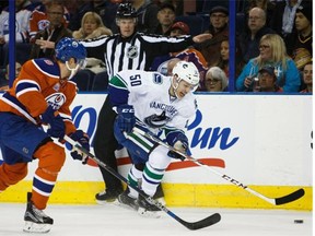 Griffin Reinhart of the Edmonton Oilers defends against Canucks forward Brendan Gaunce on Friday. Gaunce had a goal disallowed and Vancouver lost 2-0, which may have implications on the team’s draft position.