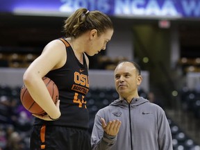 Oregon State's 6-foot-6 Ruth Hamblin towers over her head coach Scott Rueck during practice Saturday in Indianapolis. (Michael Conroy, AP)