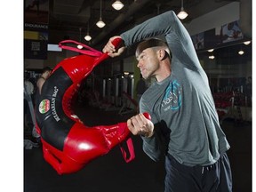 Chad Benson, Director of fitness education for Steve Nash Sports Clubs demonstrates a functional fitness training move using a Bulgarian bag.