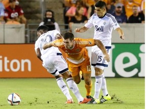 Houston Dynamo forward Will Bruin attempts to break through the Whitecaps defence last year in Houston. The Caps play two games in Texas this July, when the temperatures average in the mid-90s F (mid-30s C) in Dallas and Houston.